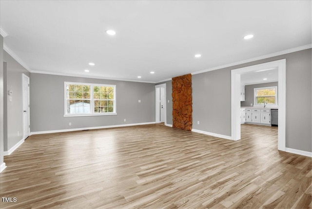 unfurnished living room featuring ornamental molding and light wood-type flooring