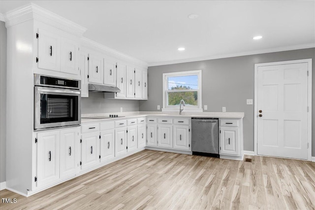 kitchen with crown molding, appliances with stainless steel finishes, white cabinetry, and light hardwood / wood-style floors