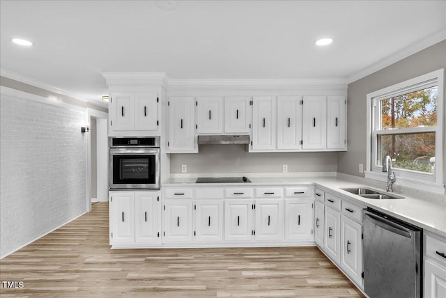 kitchen featuring sink, appliances with stainless steel finishes, and white cabinetry