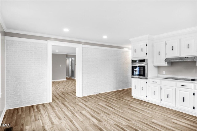 kitchen featuring stainless steel oven, white cabinetry, and light wood-type flooring