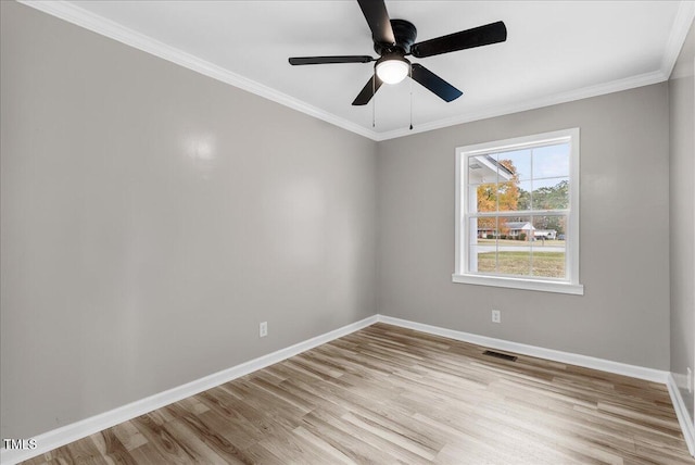 spare room with crown molding, light hardwood / wood-style flooring, and ceiling fan