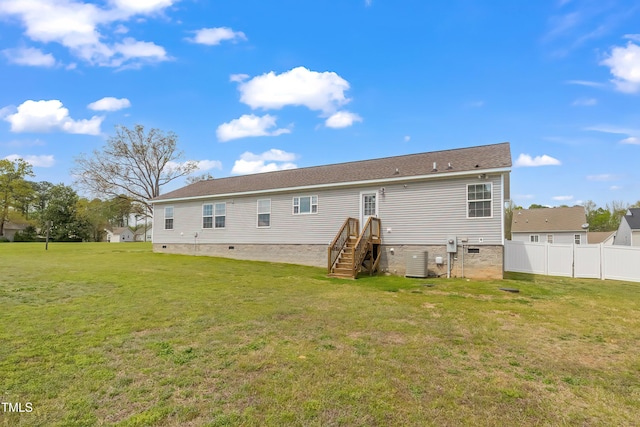 rear view of property featuring a lawn