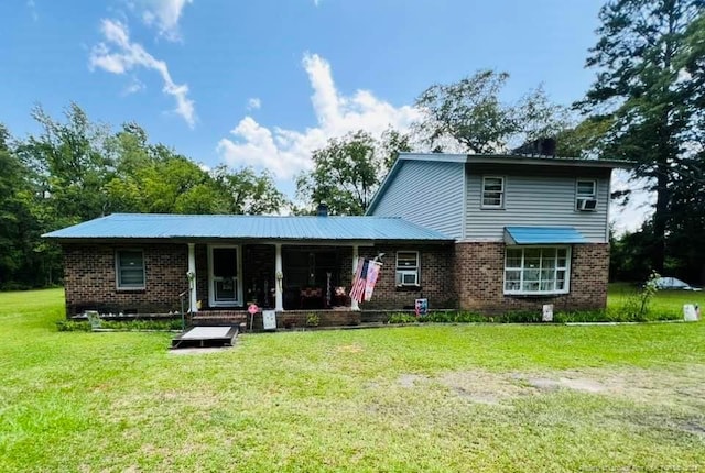 rear view of property with a lawn