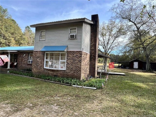 view of side of home featuring cooling unit and a yard