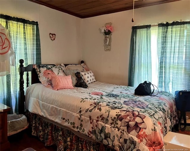 bedroom featuring multiple windows, wooden ceiling, and crown molding