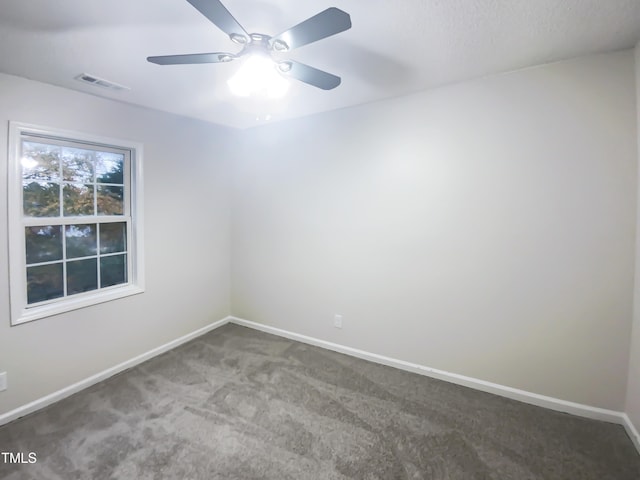 carpeted spare room with ceiling fan