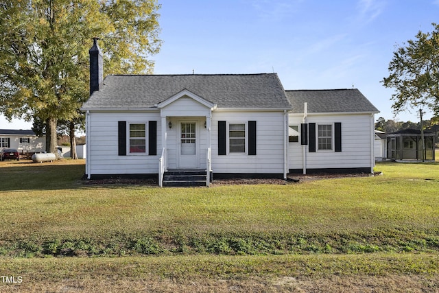 2494 Joel Johnson Rd, Lillington, NC 27546 - view of front of house with a chimney, a front yard, and a shingled roof