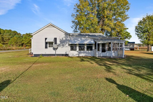 rear view of house with a lawn