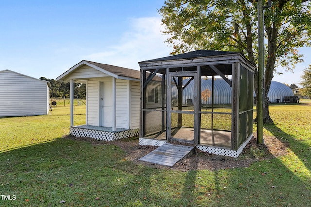 view of outbuilding featuring a lawn