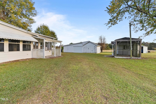 view of yard with a sunroom and an outdoor structure