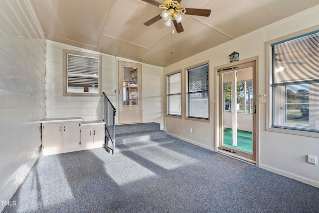 interior space with ceiling fan