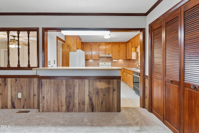 kitchen featuring light carpet, sink, a textured ceiling, white appliances, and crown molding