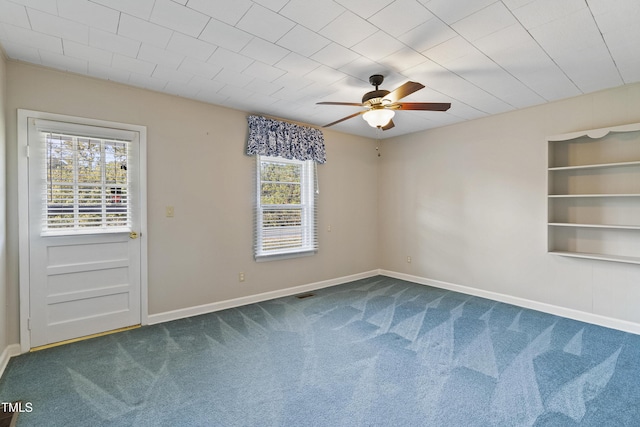 2494 Joel Johnson Rd, Lillington, NC 27546 - empty room with dark colored carpet, ceiling fan, baseboards, and built in features