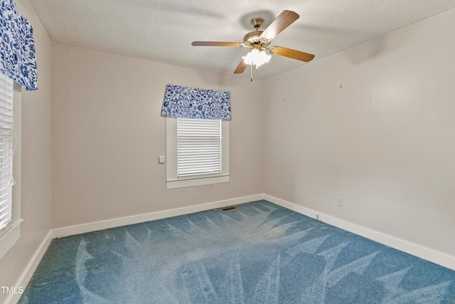 empty room with carpet flooring, a textured ceiling, and ceiling fan