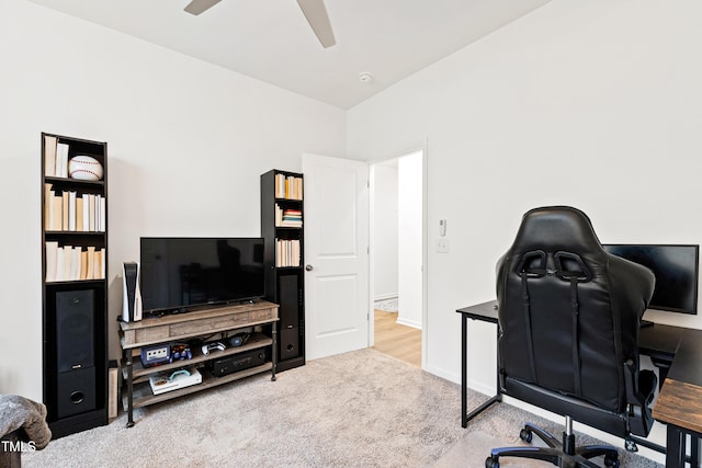 carpeted office with a ceiling fan and baseboards
