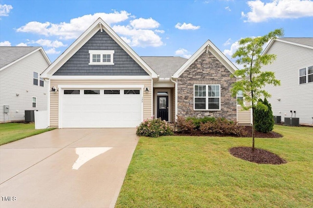 craftsman house featuring driveway, a garage, a front lawn, stone siding, and central AC unit