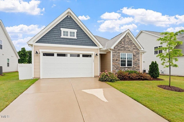 craftsman inspired home featuring stone siding, driveway, a front lawn, cooling unit, and an attached garage