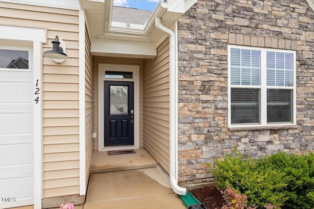 view of exterior entry featuring stone siding