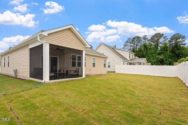 back of property featuring a ceiling fan and a sunroom