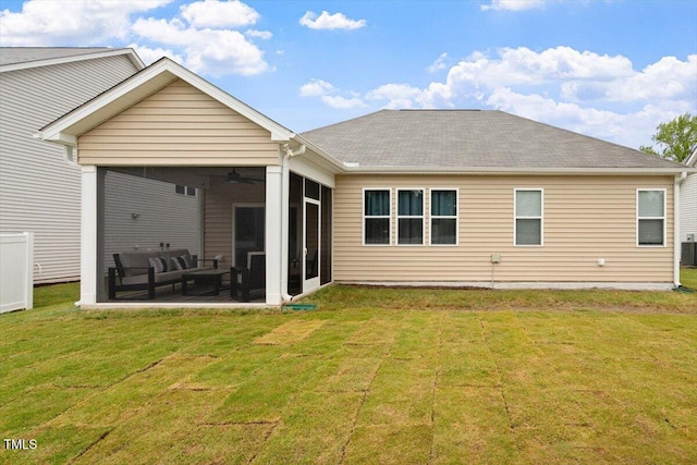 rear view of house with a sunroom, a shingled roof, a yard, central AC, and an outdoor living space
