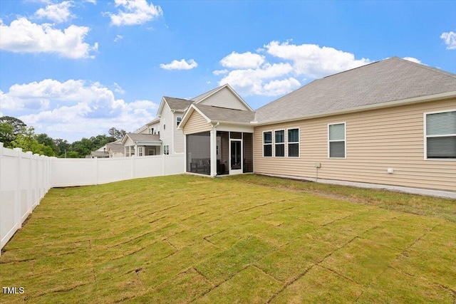 rear view of house featuring a sunroom