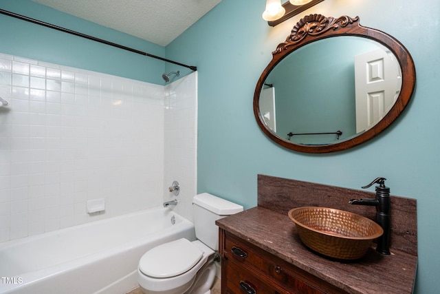 full bathroom with vanity, toilet, washtub / shower combination, and a textured ceiling