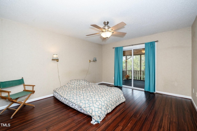 bedroom featuring dark hardwood / wood-style floors, ceiling fan, access to exterior, and a textured ceiling