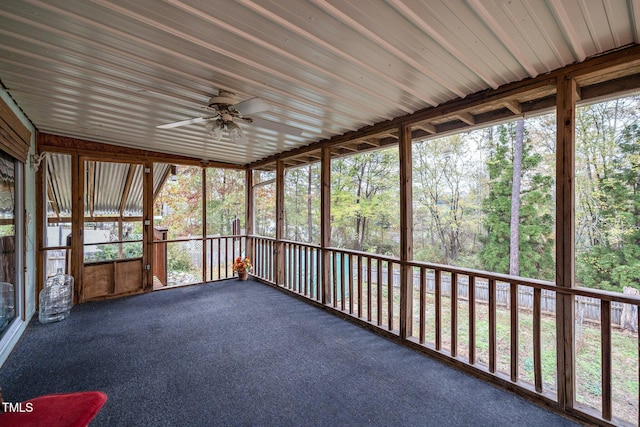 unfurnished sunroom with ceiling fan