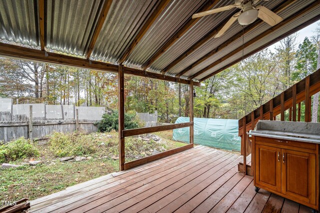 wooden deck featuring ceiling fan