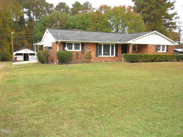 ranch-style house with an outbuilding, a garage, and a front yard