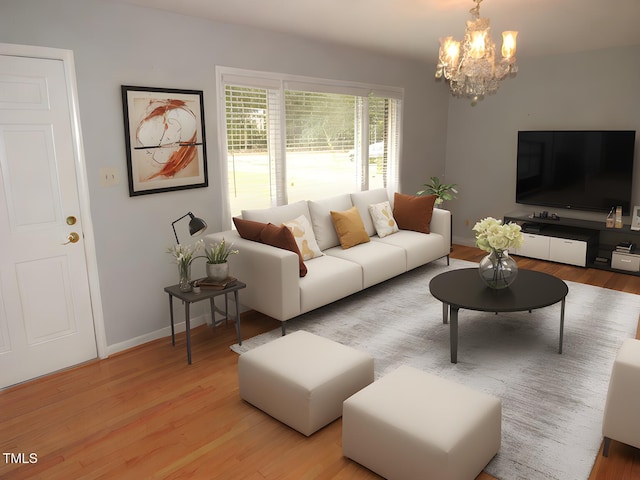 living room featuring an inviting chandelier and light hardwood / wood-style floors