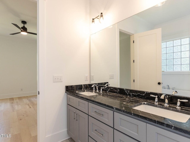 bathroom with ceiling fan, wood-type flooring, and vanity