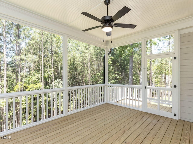 unfurnished sunroom with ceiling fan