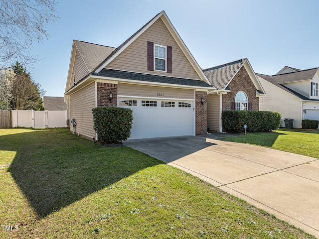 view of front of home with a front lawn and a garage