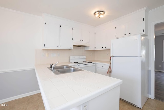 kitchen featuring white appliances, backsplash, sink, tile counters, and kitchen peninsula