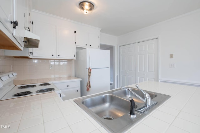 kitchen with white cabinets, tile counters, and white appliances