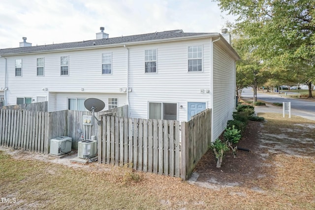 rear view of property featuring central air condition unit