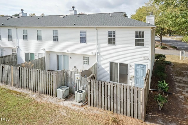 rear view of house featuring central AC