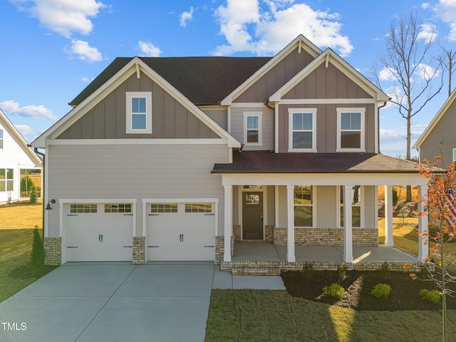 craftsman inspired home featuring a garage, covered porch, and a front yard