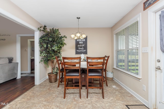 dining room with a chandelier and light hardwood / wood-style floors