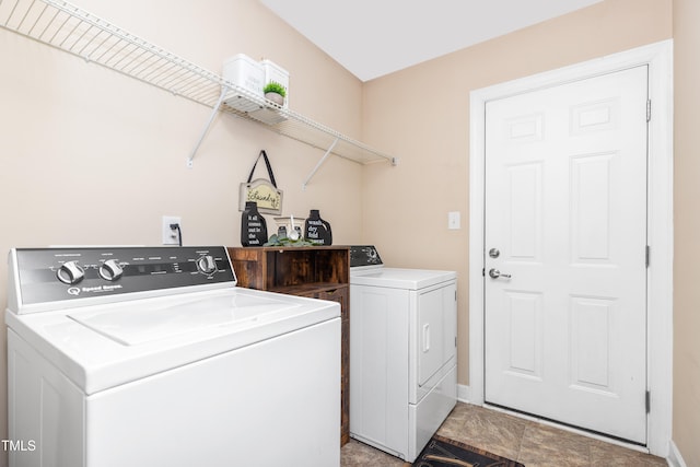 clothes washing area with washing machine and clothes dryer