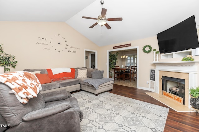 living room featuring lofted ceiling, wood-type flooring, ceiling fan, and a fireplace