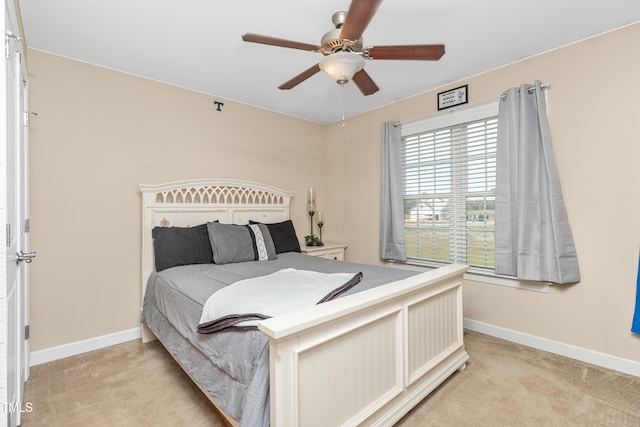 bedroom featuring ceiling fan and light carpet