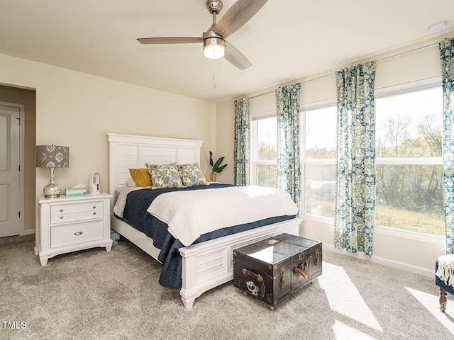 bedroom featuring light colored carpet and ceiling fan