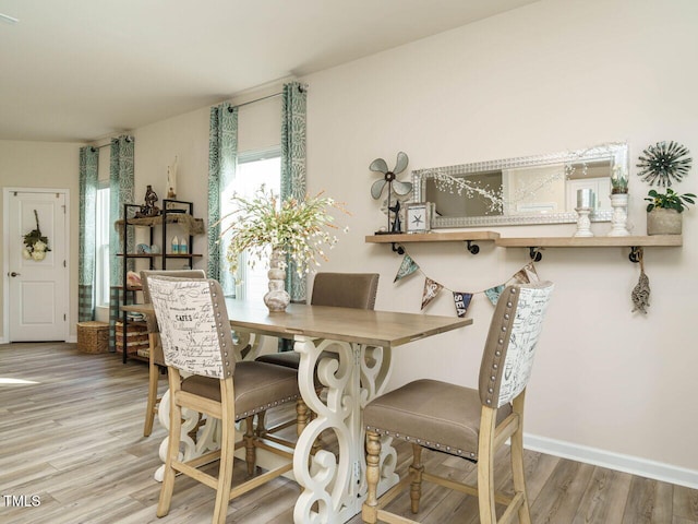 dining space with light hardwood / wood-style flooring