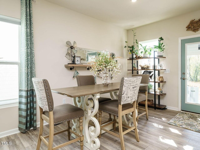 dining space with light hardwood / wood-style floors