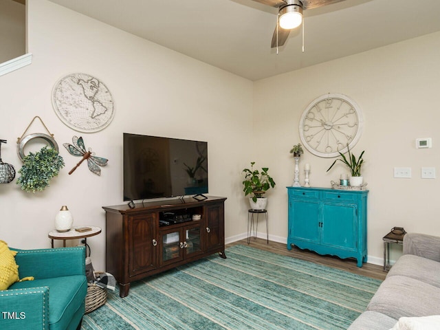 living room featuring dark hardwood / wood-style flooring and ceiling fan