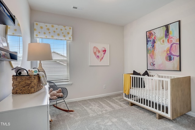 carpeted bedroom featuring a crib