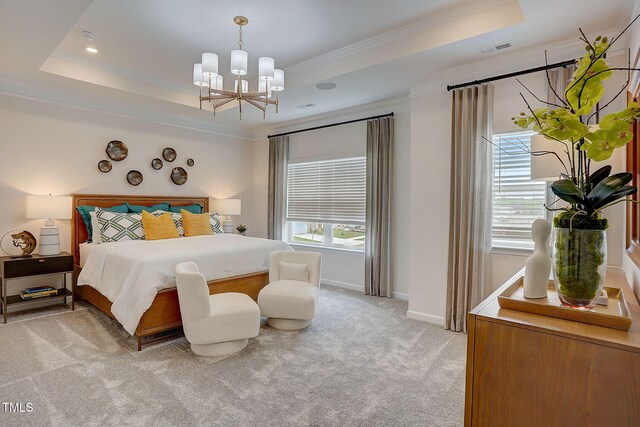 carpeted bedroom featuring crown molding, a notable chandelier, and a tray ceiling