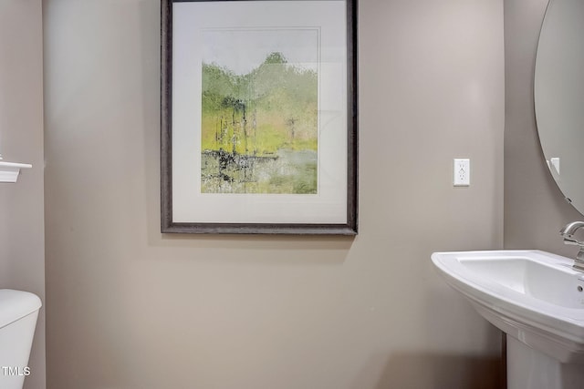 bathroom featuring sink and toilet